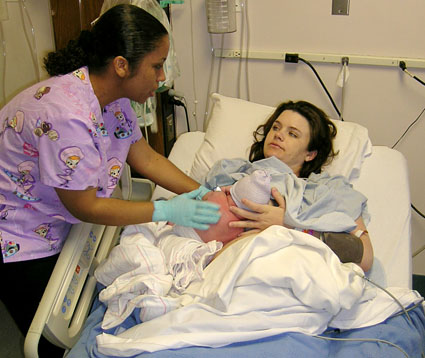 Jenn holding James for the first time in the recovery room