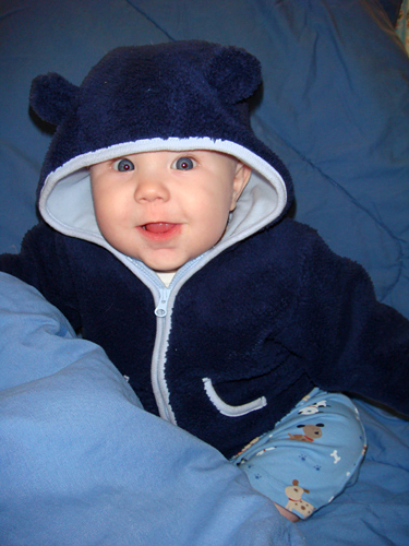 James laughing in a jacket with bear ears on the hood