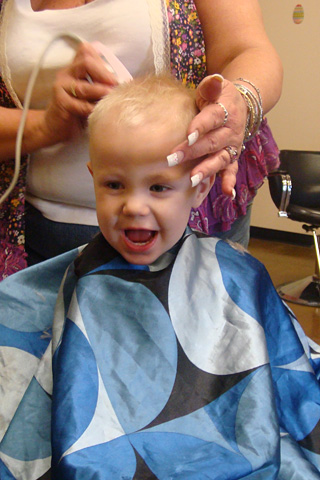 James laughs as he gets his hair cut
